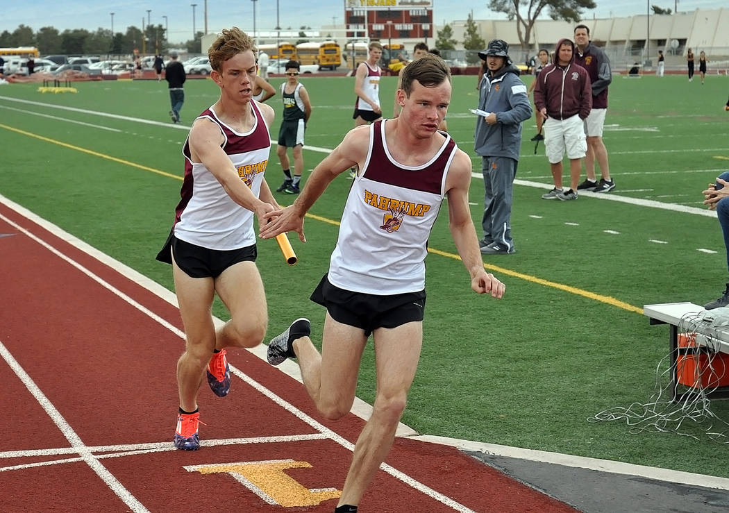 Horace Langford Jr./Pahrump Valley Times 
Pahrump Valley senior Bryce Odegard, right, receives the baton from Layron Sonerholm during a March 21 meet at Pahrump Valley High School. Odegard posted  ...