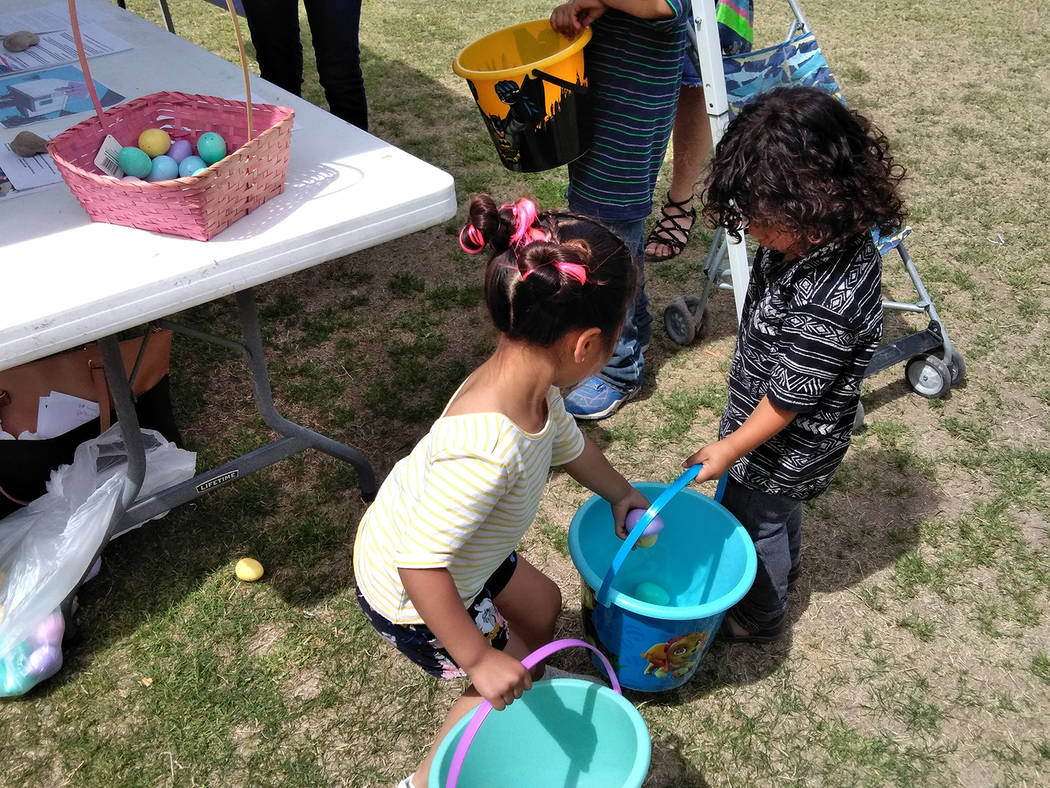 Selwyn Harris/Pahrump Valley Times
Siblings help one another amass as many eggs as possible while traipsing around Petrack Park during Saturday's Community Easter Picnic. The free event, was hoste ...