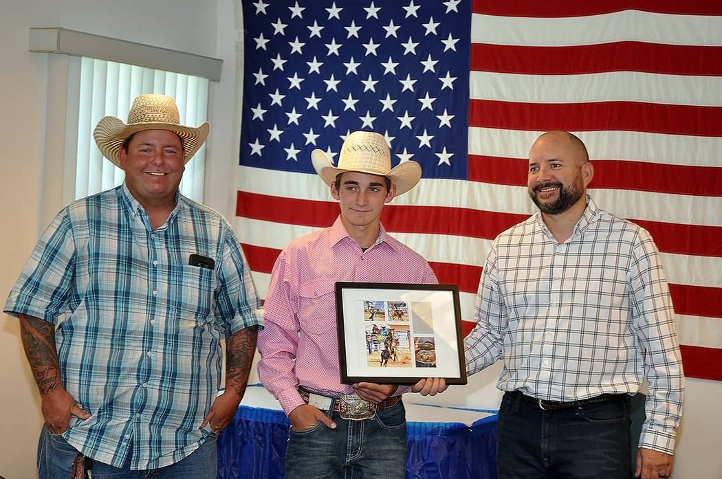 Horace Langford Jr./Pahrump Valley Times Pahrump Valley High School rodeo director Buddy Krebs, left, and junior high rodeo competitor Josh Dobbins of Las Vegas make a presentation to Pahrump Vall ...