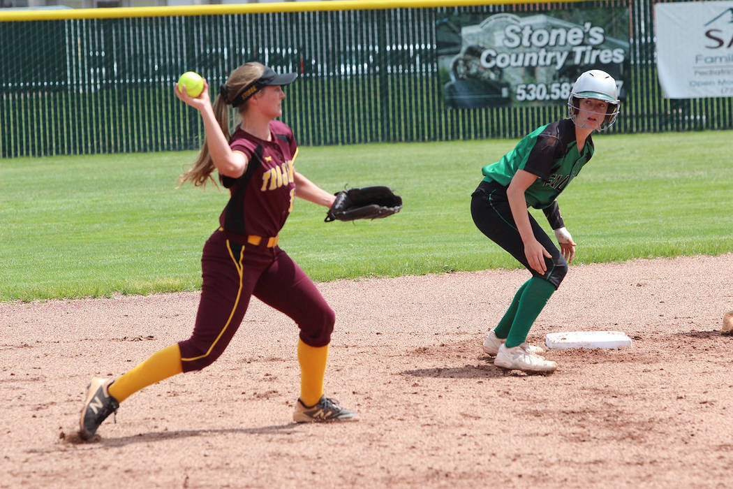Steve Ranson/Special to the Pahrump Valley Times Jackie Stobbe, left, holds the runner at second base before firing to first base for an out during Pahrump Valley's 12-2 loss to Churchill County i ...