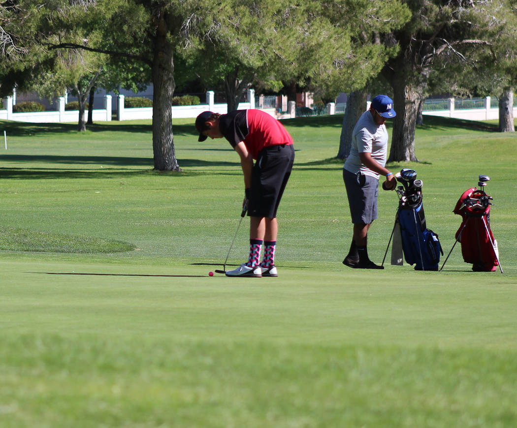 Tom Rysinski/Times-Bonanza & Goldfield News Tonopah junior Kevin Pope putts on the 18th green during the Class 2A state tournament May 17 at Boulder City Municipal Golf Course.