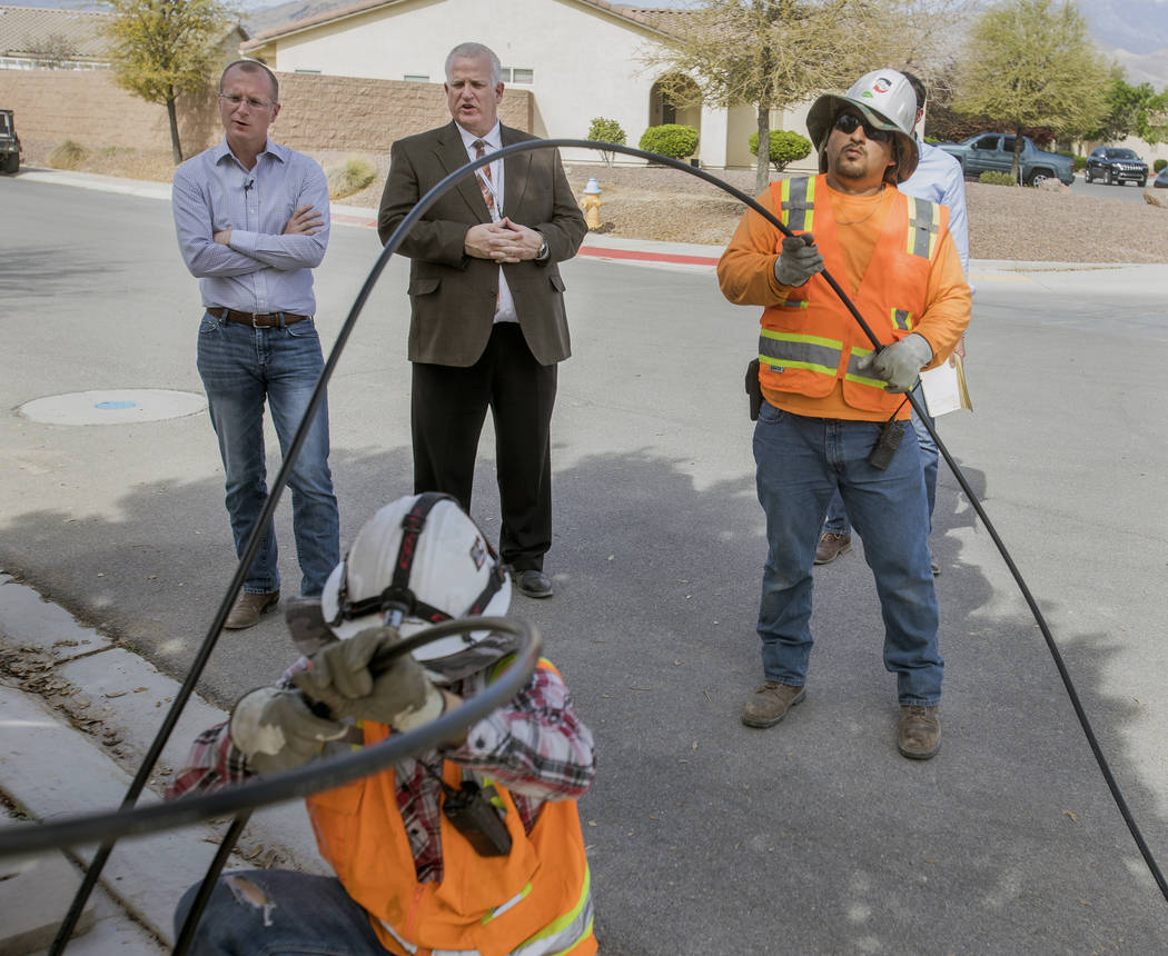 Special to the Pahrump Valley Times/Jeff Scheid Federal Communications Commissioner Brendan Carr (left) looks on as workers lay fiber-optic cables on April 9, 2018. Carr is working to reduce what ...