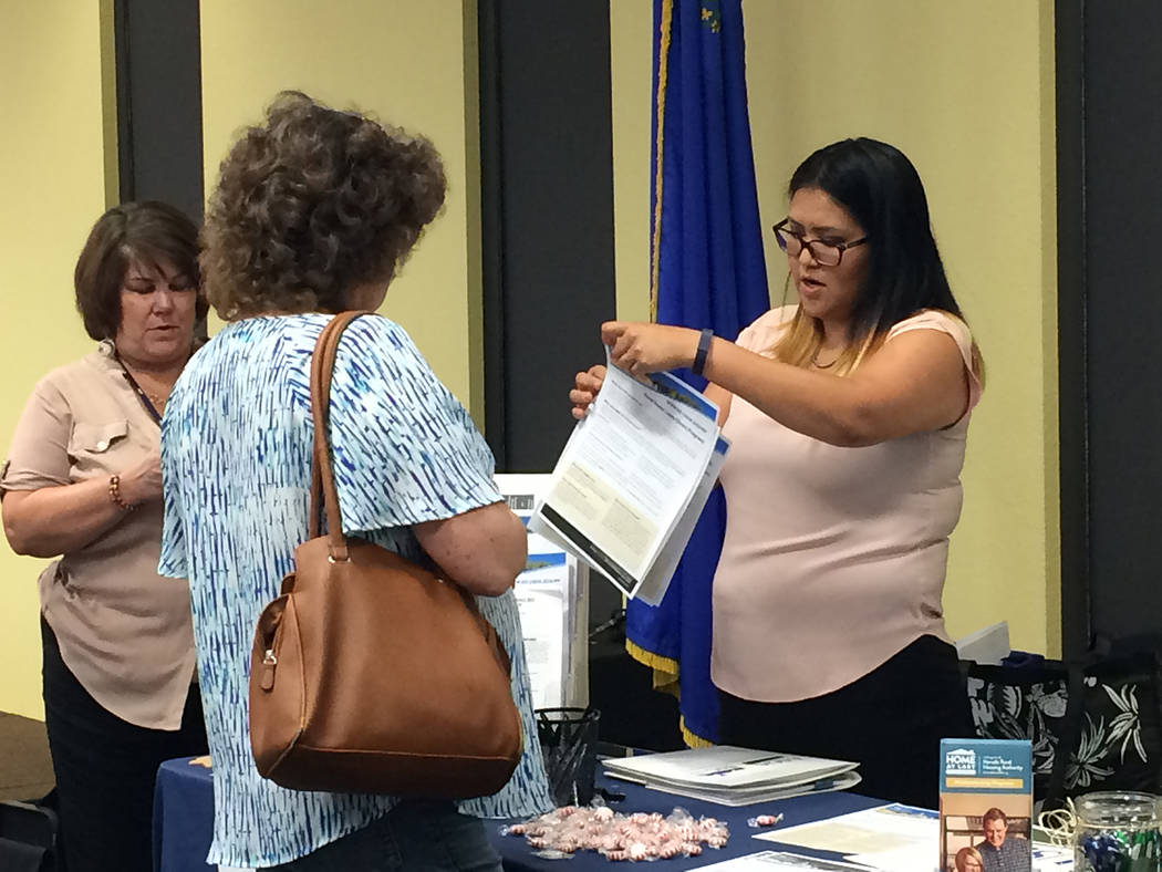 Robin Hebrock/Pahrump Valley Times USDA Single-family Housing Technician Michelle Joe is pictured giving a Pahrump resident a run-down of the organization's rural housing programs during an event ...