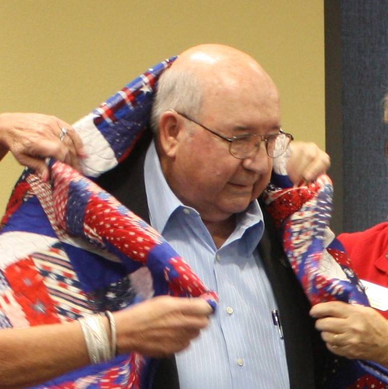 Robin Hebrock/Pahrump Valley Times Veteran William Rettig, U.S. Air Force retired, is pictured in the moment when Nye County Valor Quilters draped his new quilt of valor over his shoulders, envelo ...
