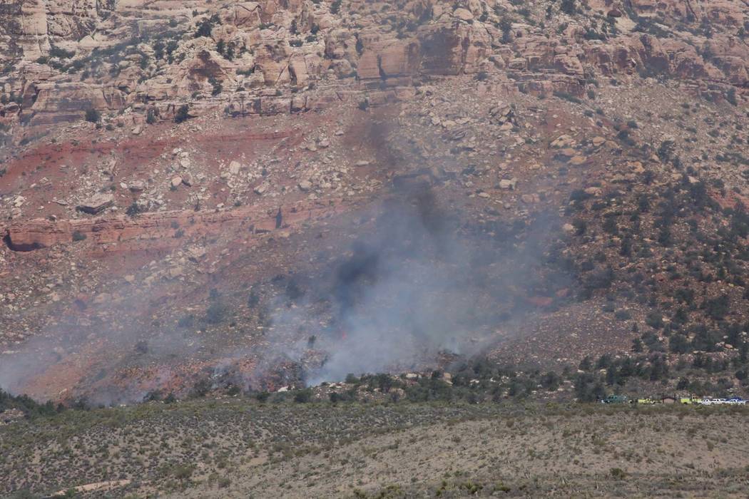 Bizuayehu Tesfaye/Las Vegas Review-Journal Smoke from a wildfire is seen at the Pine Creek trail, off the 13-mile scenic loop of the Red Rock National Conservation Area on Friday, June 22, 2018, ...