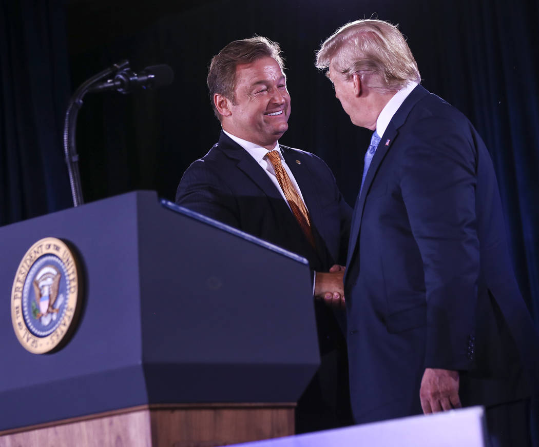 President Donald Trump greets U.S. Sen. Dean Heller, R-Nev., during the keynote address at the Nevada Republican Party State Convention at the Suncoast in Las Vegas on Saturday, June 23, 2018. Cha ...