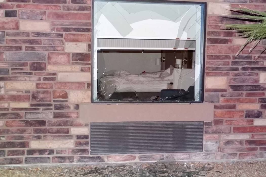 A screenshot from video shows a broken window at a Pahrump hotel room where Nye County Sheriff's officers were pursuing suspects. (Nye County Sheriff's Office)
