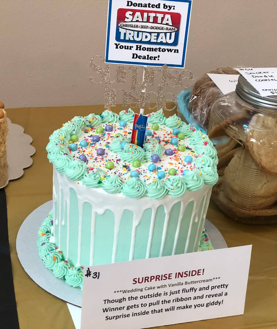 Tom Rysinski/Pahump Valley Times There really was a surprise inside the "surprise cake" donated by Saitta-Trudeau Chrysler Jeep Dodge Ram: a coupon for a free oil change and 20 $5 bills.