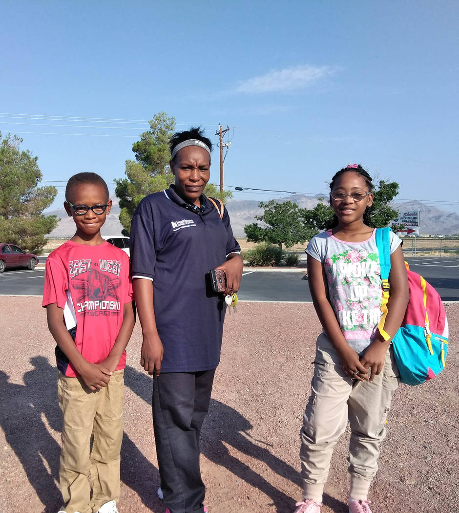 Selwyn Harris/Pahrump Valley Times local resident and mother Lesa Chandler, center, snapped a photo of her son, Damarion, left, and daughter Destiney prior to escorting the siblings on campus. Ch ...