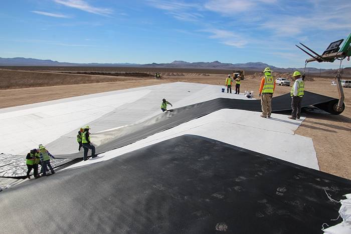 Special to the Pahrump Valley Times/U.S. Department of Energy Workers install the first of two liners for a mixed low-level disposal cell at the Nevada National Security Site. The project was comp ...