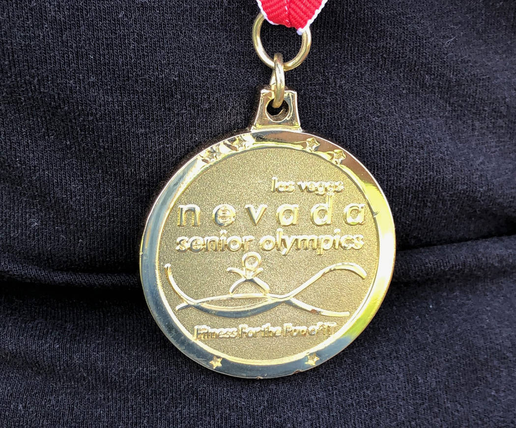 Tom Rysinski/Pahrump Valley Times Pahrump resident Cathy Behrens displays the gold medal she won last year in the 75-to-79 division of the 50-meter freestyle in the Nevada Senior Games.