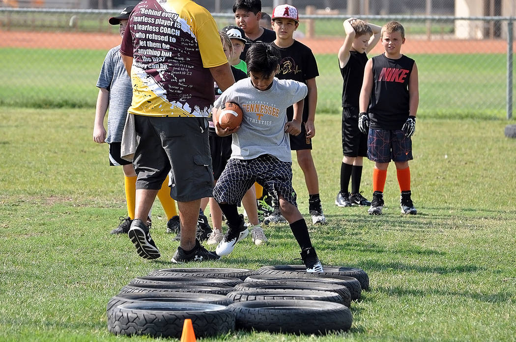 Horace Langford Jr./Pahrump Valley Times Pahrump youth football players go through drills during a July combine at Petrack Park. Three Pahrump teams will play their second game of the season Satur ...