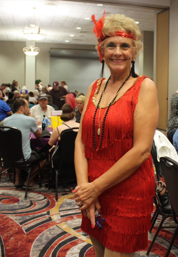 Robin Hebrock/Pahrump Valley Times Ms. Senior Golden Years USA and Nevada Silver Tappers member Michelle Caird sports a flashy, red flapper dress and matching headband at the Roaring 20s fundraiser.
