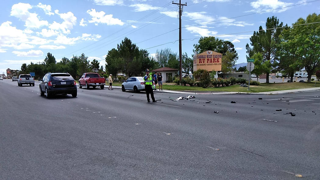Selwyn Harris/Pahrump Valley Times A Nye County Sheriff's Office auxiliary officer directs traffic as law enforcement crews investigate a two vehicle crash at Highway 160 and Dandelion Street. One ...