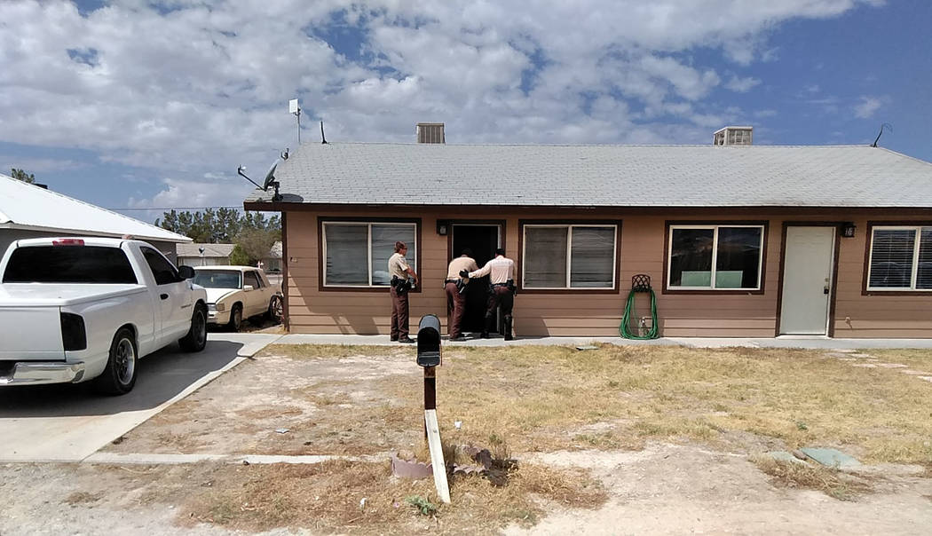 Selwyn Harris/Pahrump Valley Times Nye County Sheriff's Deputies, with guns drawn storm a Galaxy Avenue residence after a reported burglary in progress just before 11 a.m., on Tuesday September 4. ...