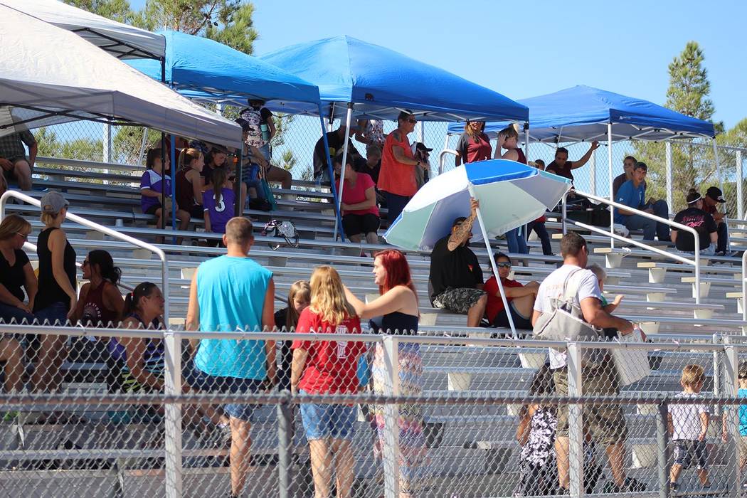 Tom Rysinski/Pahrump Valley Times With temperatures well into the 90s, prudent parents brought their own shade for the Junior Trojans and Junior Warriors games Saturday at Pahrump Valley High School.