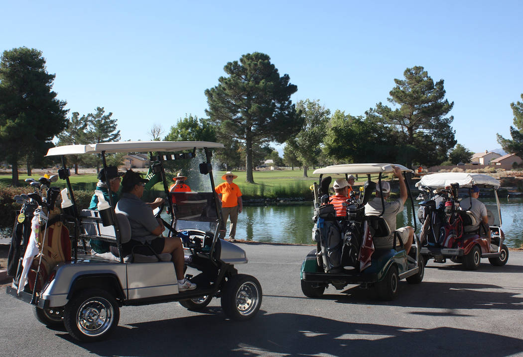 Robin Hebrock/Pahrump Valley Times A parade of golf carts process down to their starting positions for the 18-hole scramble-style golf tournament.