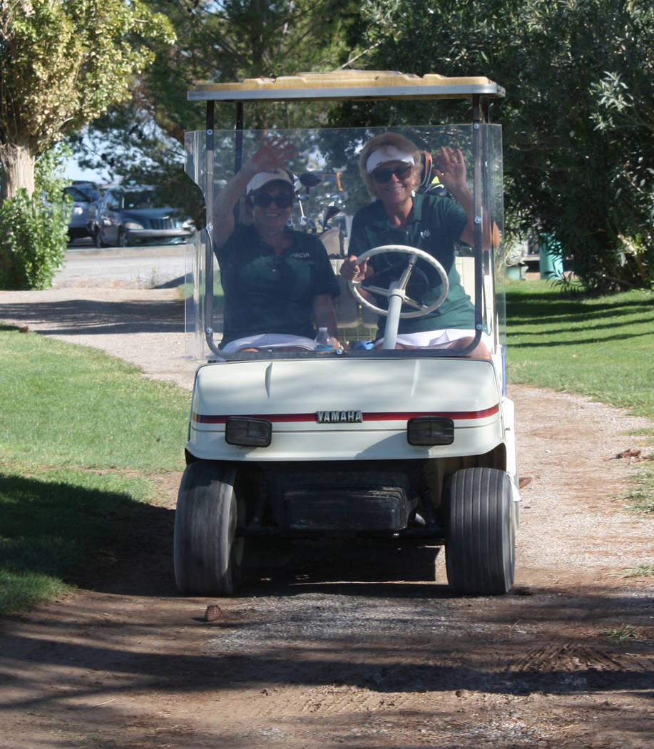 Robin Hebrock/Pahrump Valley Times Ms. Senior Golden Years and Nevada Silver Tapper members wave from their golf tournament on their way down to the green.