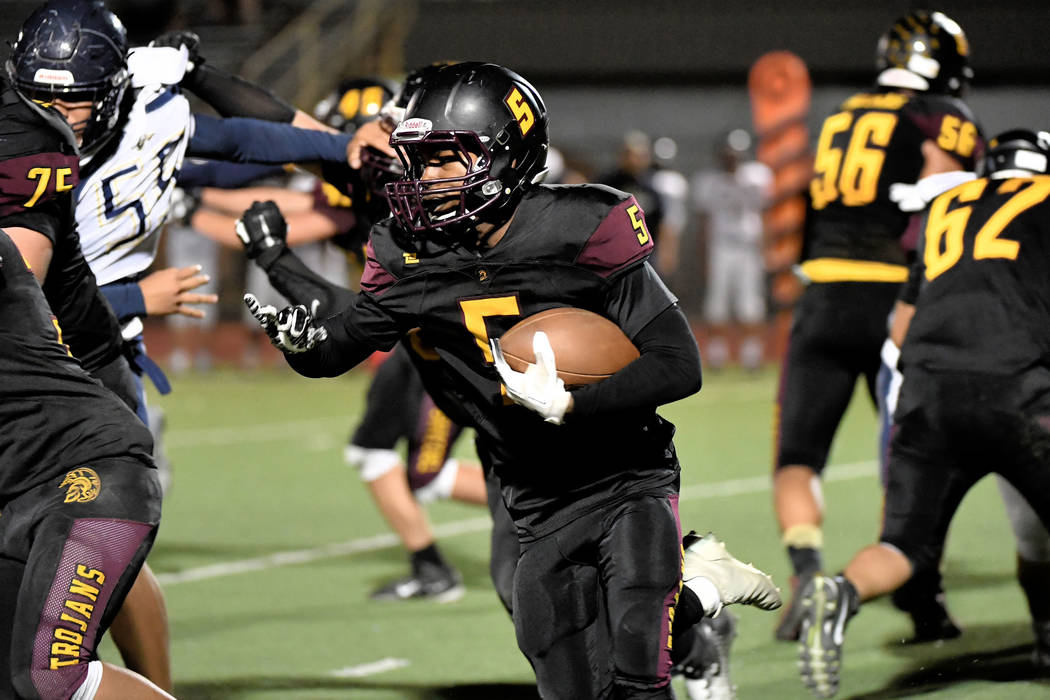 Peter Davis/Special to the Pahrump Valley Times Senior Casey Flennory led Pahrump Valley's rushing attack with 126 yards Friday night as the Trojans dominated Cheyenne 38-12 to move into first pla ...
