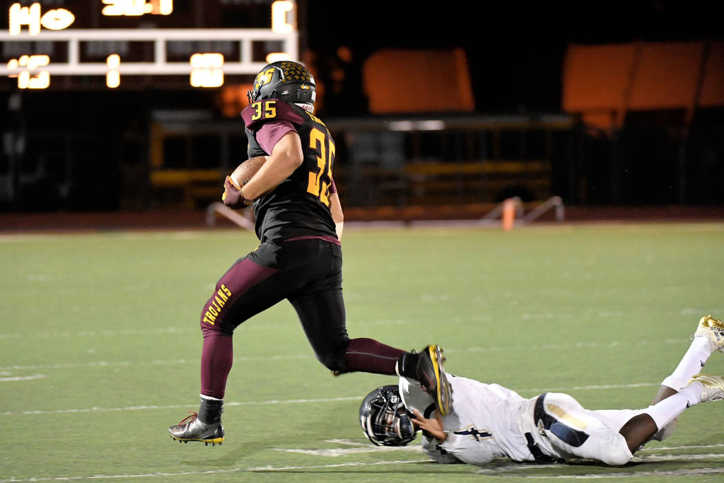 Peter Davis/Special to the Pahrump Valley Times Nico Velazquez breaks free for some of his 104 rushing yards as three Pahrump Valley backs reached 100 yards in the Trojans' 38-12 rout of Cheyenne ...