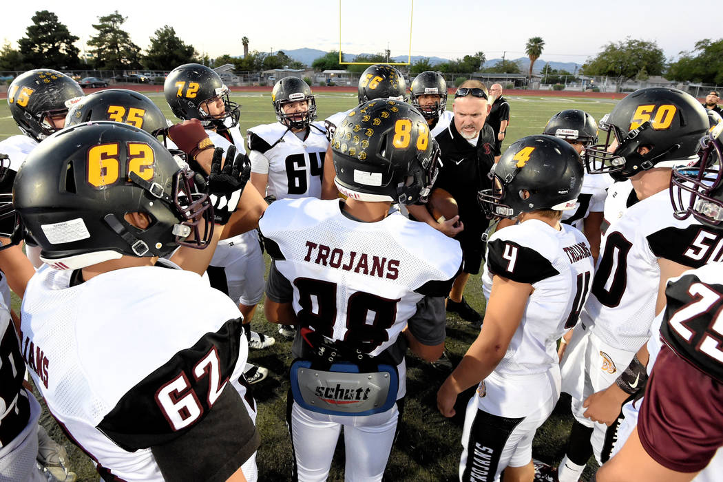 Peter Davis/Special to the Pahrump Valley Times Pahrump Valley football players gather around coach Joe Clayton for a pregame talk before taking on Democracy Prep, the first of what has become thr ...
