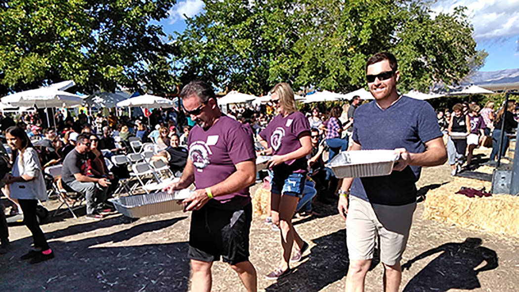 Selwyn Harris/Pahrump Valley Times Competitors carefully carry the fruit juice of their labor to the judging table. More than 30 vendors set up shop on the winery grounds this year. The winery rec ...