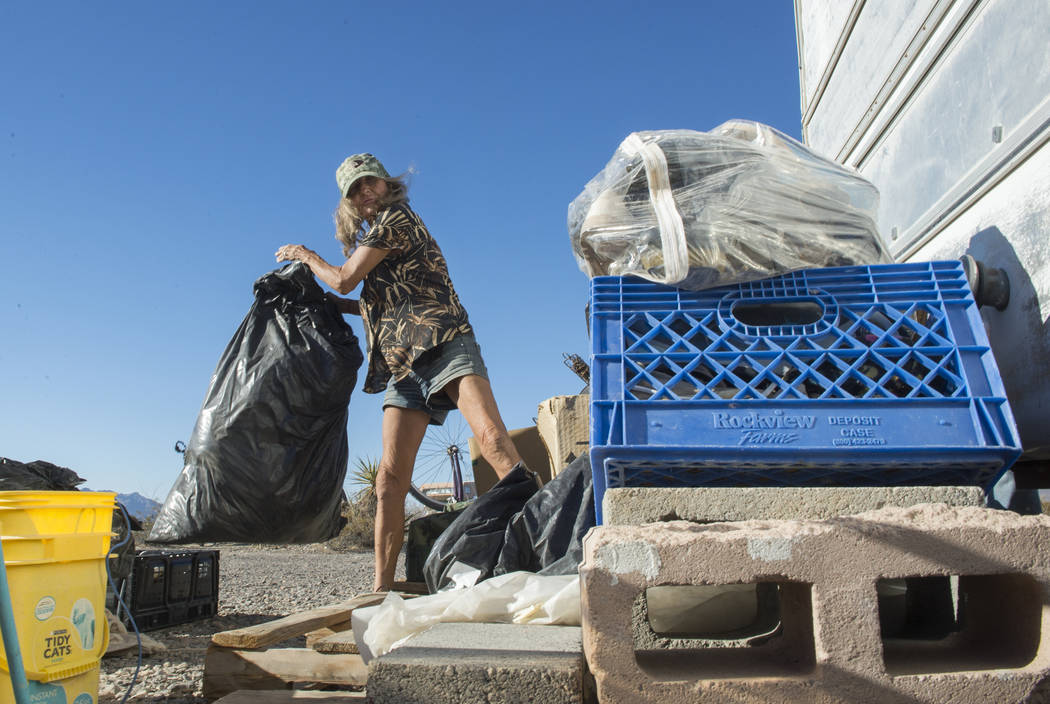 Homeless resident Mary Supples packs up her belongings laying outside of her trailer in preparation of moving her trailer to a third location within two weeks in Pahrump, Wednesday, Sept. 26, 2018 ...