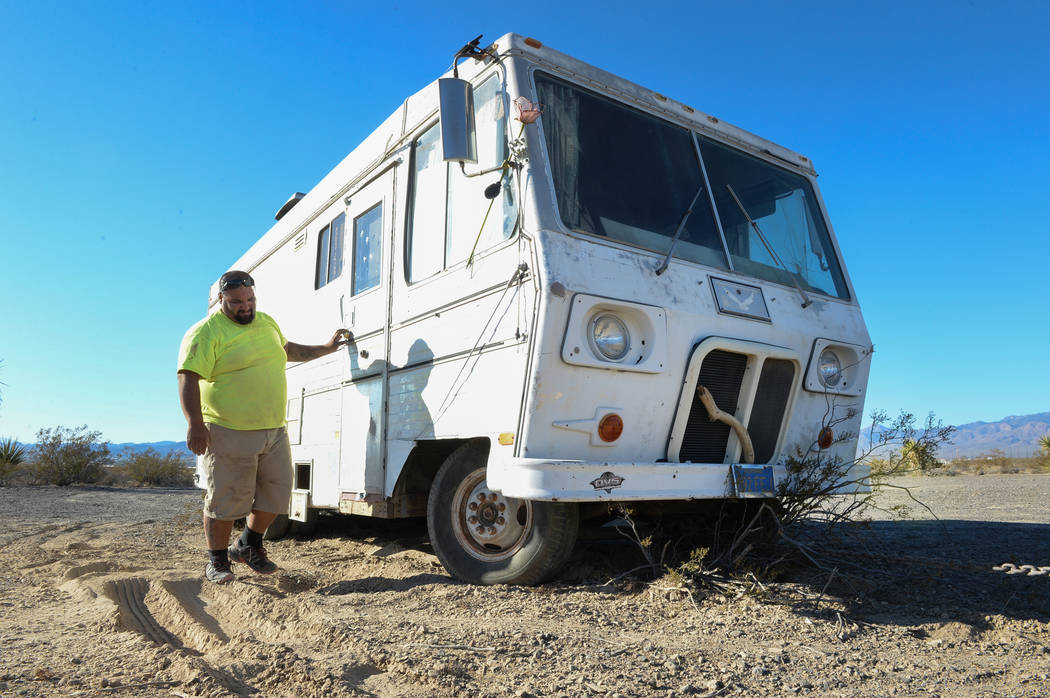 Jon Olivas of Platinum Hauling looks down at the bush Mary Supples' trailer got caught on while being pulled by Olivas' truck in Pahrump, Wednesday, Sept. 26, 2018. Caroline Brehman/Las Vegas Revi ...