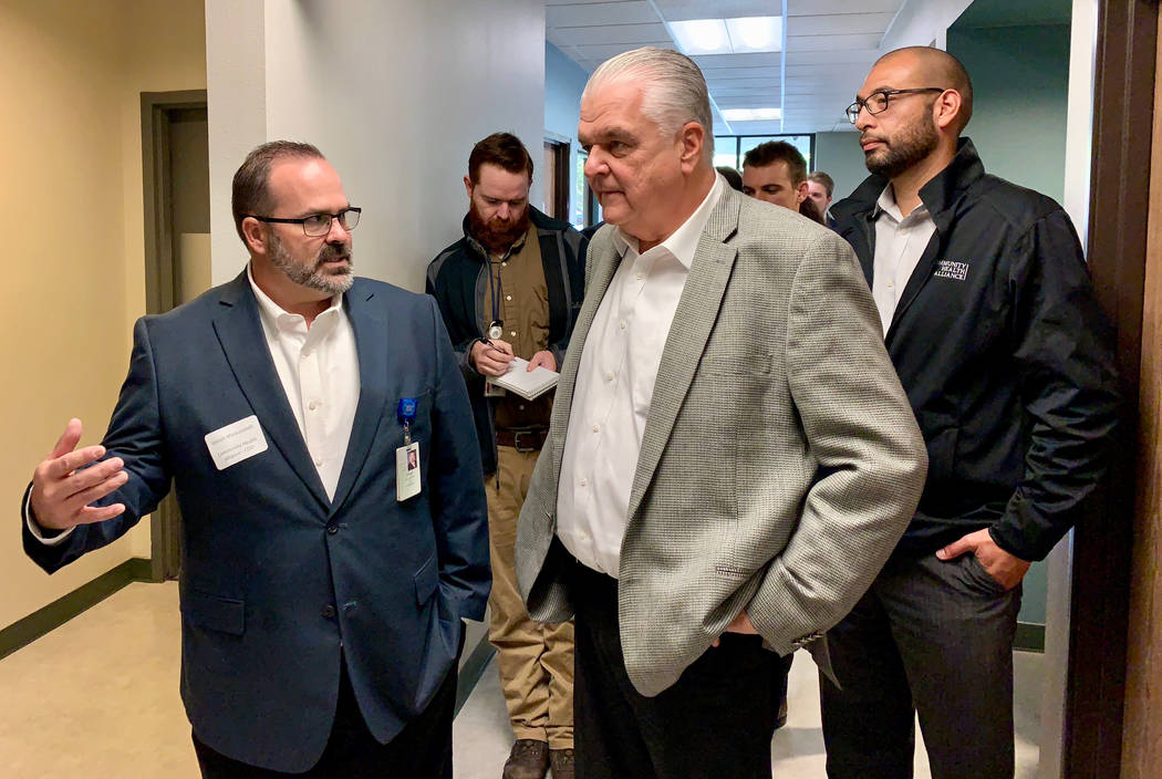 Clark County Commission Chair and Democratic candidate for Nevada governor Steve Sisolak, center, gets a tour of the Community Health Alliance's Reno facility from CHA Chief Operating Officer Jose ...