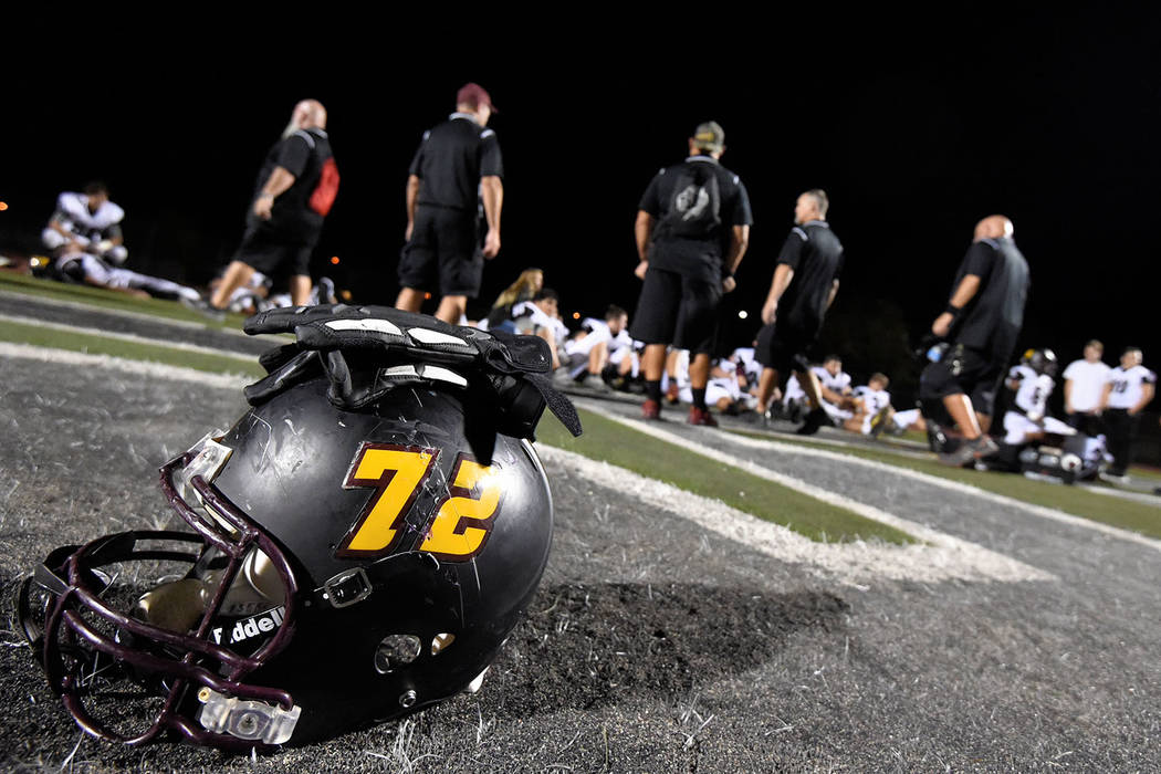 Peter Davis/Special to the Pahrump Valley Times Pahrump Valley senior Caleb Sproul's helmet is a bystander as the Trojans listen to coaches at halftime of a game against Democracy Prep on Sept. 21 ...