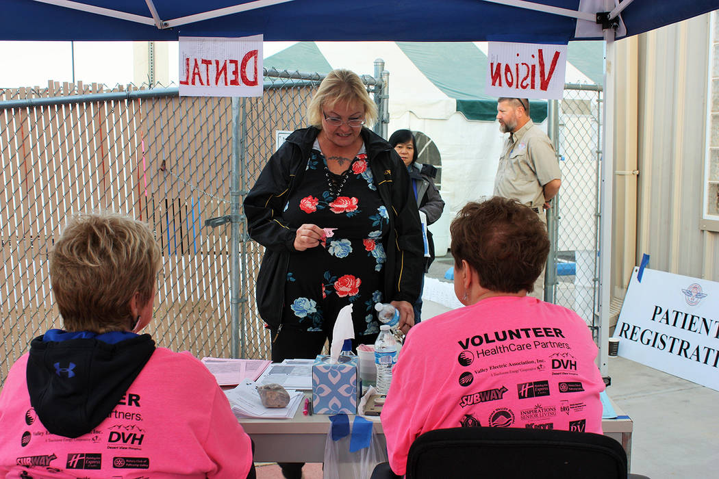Robin Hebrock/Pahrump Valley Times Helpful volunteers assist resident Nancy Paul in signing in at the registration desk for the Remote Area Medical clinic, held October 5, 6 and 7 in Pahrump.