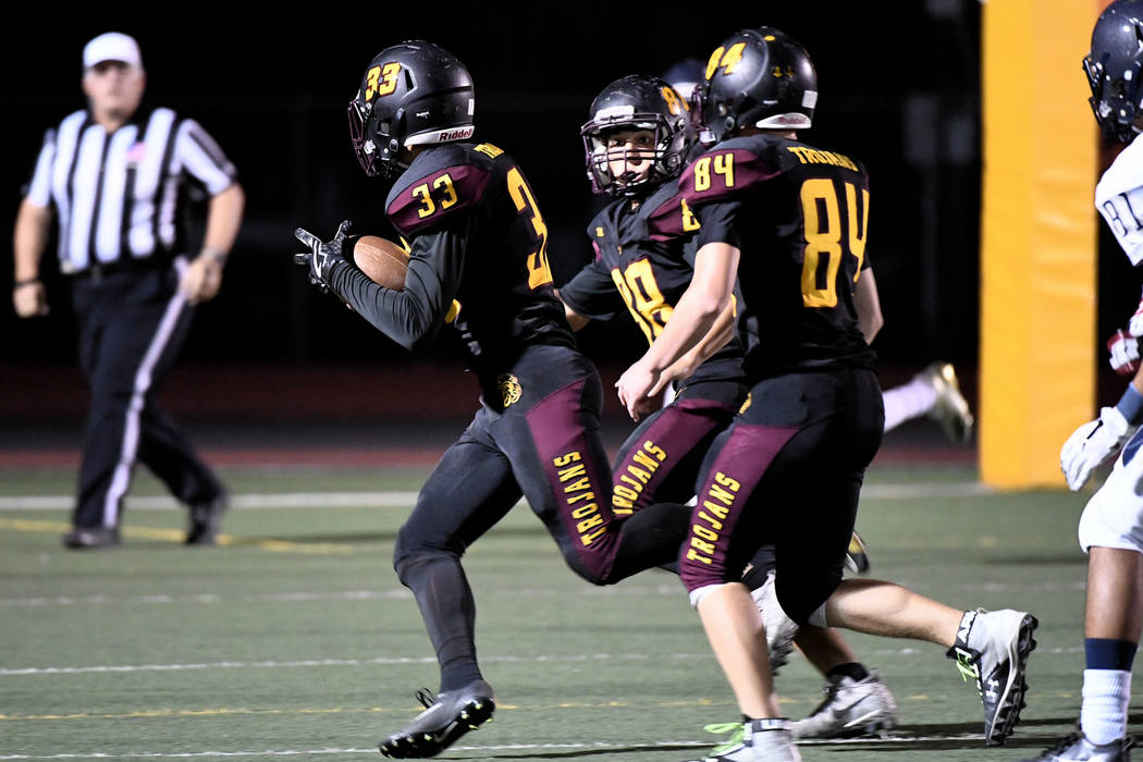 Peter Davis/Special to the Pahrump Valley Times Jalen Denton returns a blocked punt for a touchdown as Andrew Avena (84) and Antonio Margiotta (88) look for potential tacklers to block against Che ...