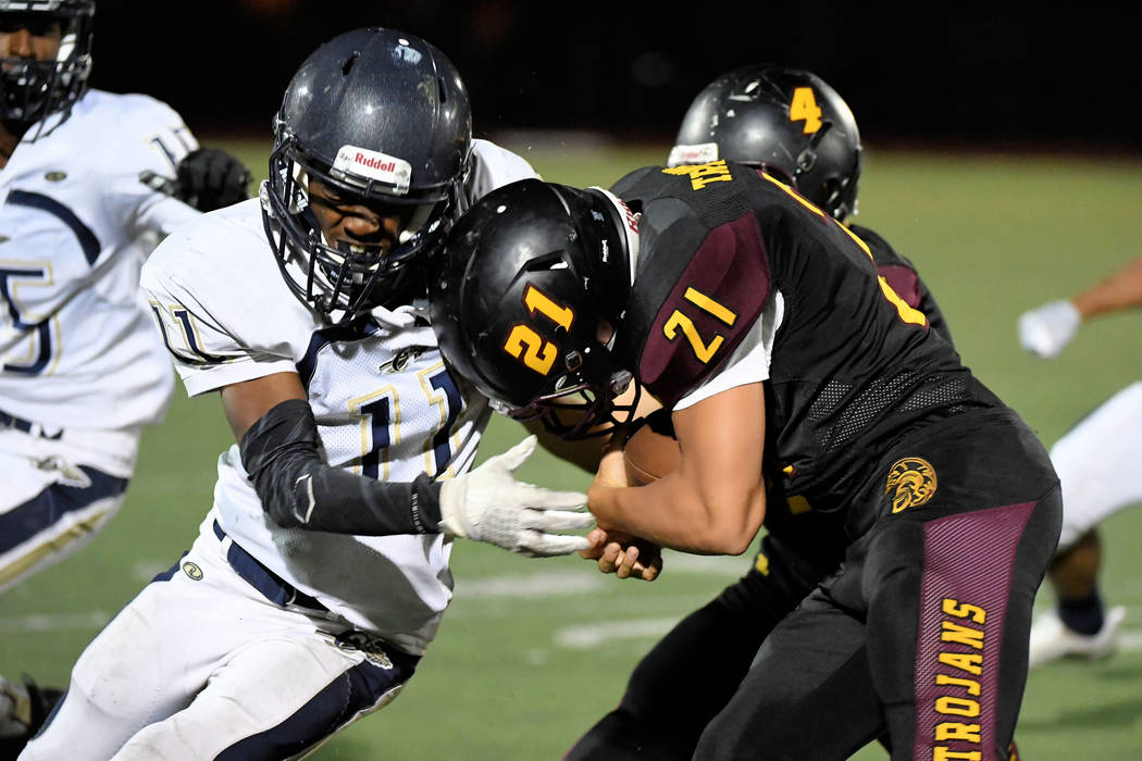 Peter Davis/Special to the Pahrump Valley Times Junior Kenny Delker tries to bull his way for extra yardage while Joshua Washington of Cheyenne tries to bring him down during Pahrump Valley's 38-1 ...