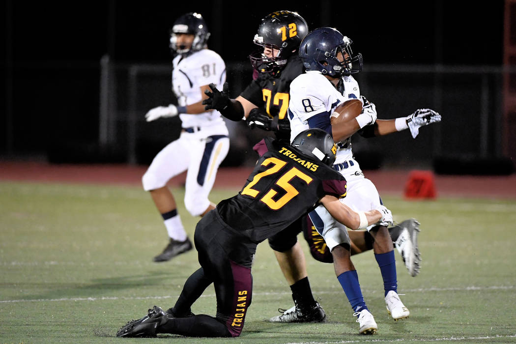 Peter Davis/Special to the Pahrump Valley Times Pahrump Valley senior Willie Lucas wraps up Cheyenne's Tayjon Bullock during the Trojans' Sept. 28 victory over the Desert Shields in Pahrump.