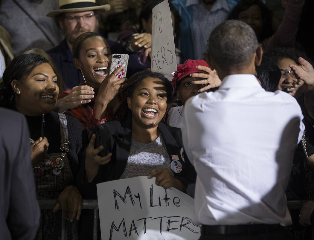 Former President Barack Obama, right, shakes hands with the crowd at Cox Pavilion after a rally on Monday, Oct. 22, 2018, in Las Vegas. Benjamin Hager Las Vegas Review-Journal