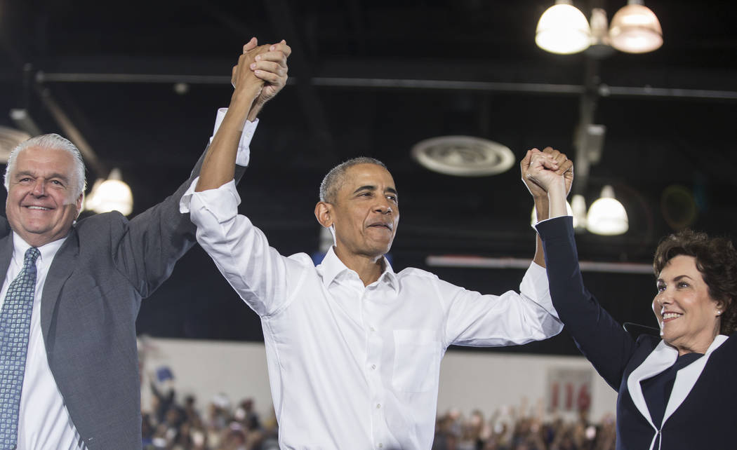 Clark County Commission Chairman Steve Sisolak, left, former President Barack Obama and Democratic Congresswoman Jacky Rosen salute the crowd during a rally at Cox Pavilion on Monday, Oct. 22, 201 ...