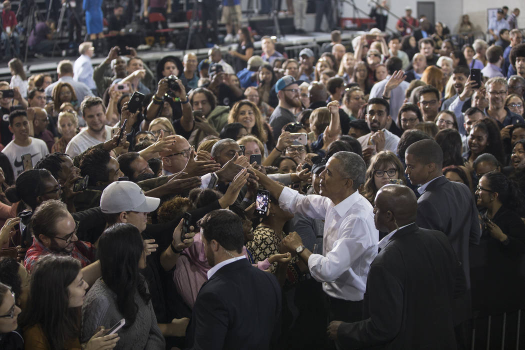 Former President Barack Obama, right, shakes hands with the crowd at Cox Pavilion after a rally on Monday, Oct. 22, 2018, in Las Vegas. Benjamin Hager Las Vegas Review-Journal