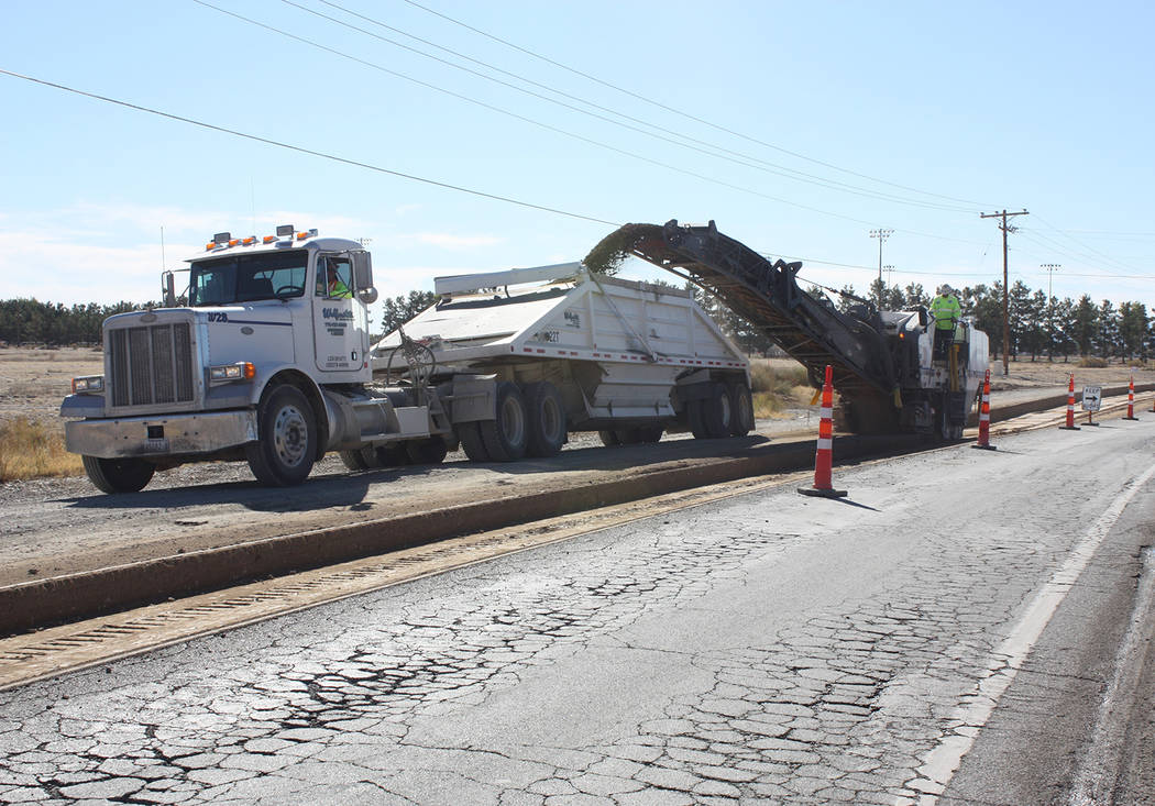 Robin Hebrock/Pahrump Valley Times Construction crews are seen grinding the existing road surface on Pahrump Valley Boulevard at East Mount Charleston Drive and loading the removed material into a ...