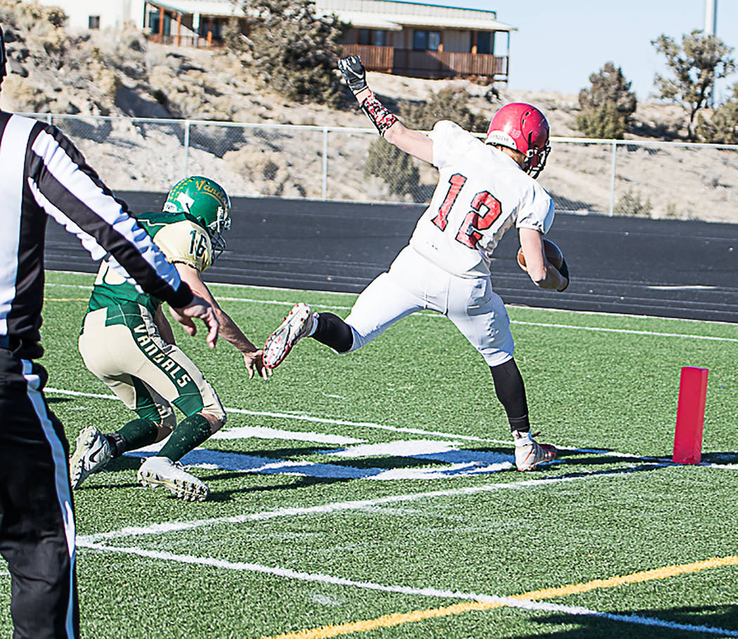 Carl Paice/Special to the Times-Bonanza Tonopah junior Kobe Bunker scores one of his four touchdowns during the Muckers' 68-20 win over Eureka on Saturday in the Class 1A state semifinals at White ...