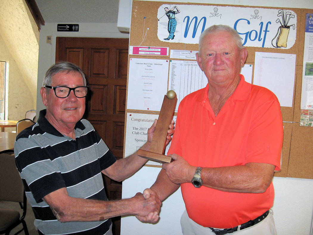 Special to the Pahrump Valley Times Ed Plavic (left) presents the championship trophy, to Ron Becker. Thirty-one players took part.