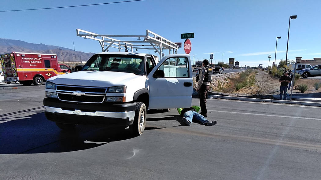 Selwyn Harris/Pahrump Valley Times A man on the pavement awaits the arrival of Pahrump emergency crews following a two-vehicle collision at the intersection of Southbound Highway 160 and Wilson Ro ...