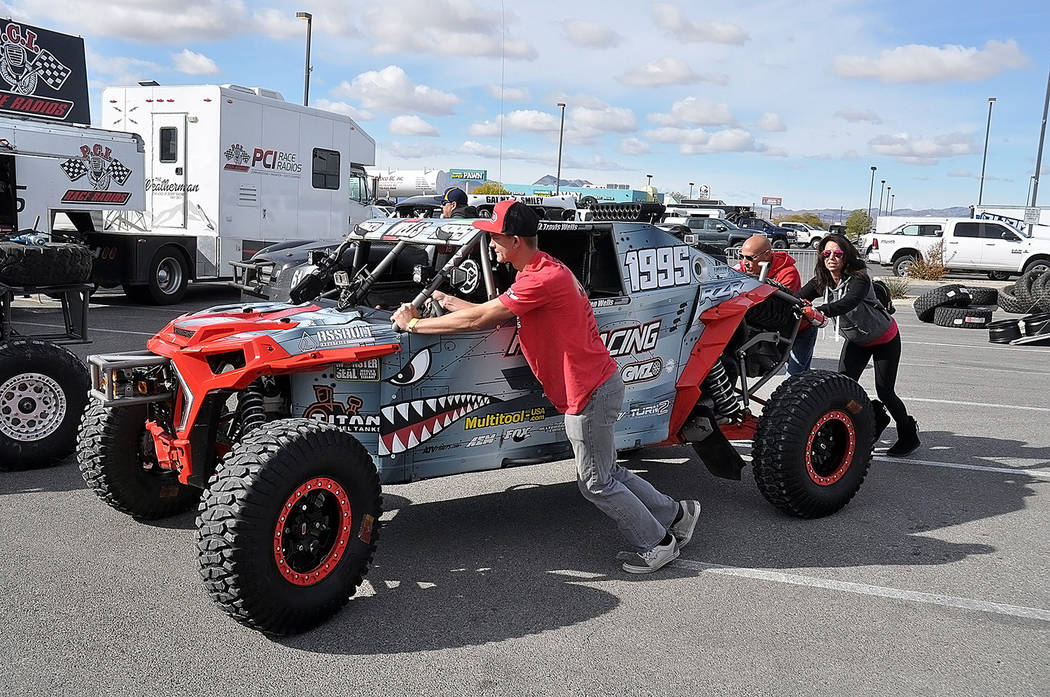 Horace Langford Jr./Pahrump Valley Times Kaden Wells of St. George, Utah, and crew members push his vehicle through the line for technical inspections before the Pahrump Nugget 250 on Kaden Wells ...