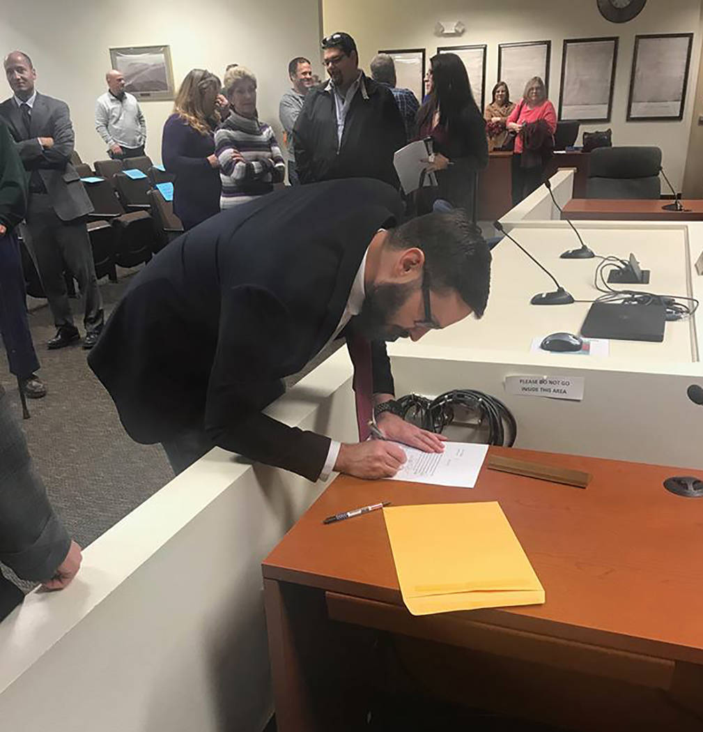 Special to the Pahrump Valley Times Greg Hafen II is shown signing his Certificate of Appointment after being selected for Dennis Hof's vacant Nevada Assembly District 36 seat on Dec. 7. Photo cou ...