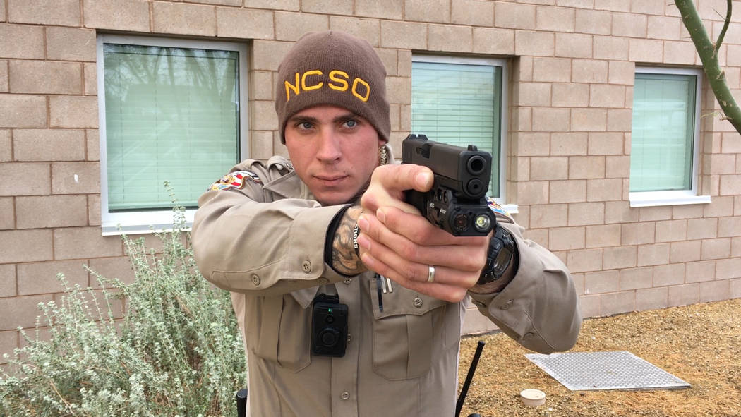 Viridian/Special to the Pahrump Valley Times (still shot from video clip) A Nye County Sheriff's Office deputy is pictured holding a firearm with new weapon-mounted camera technology that the offi ...