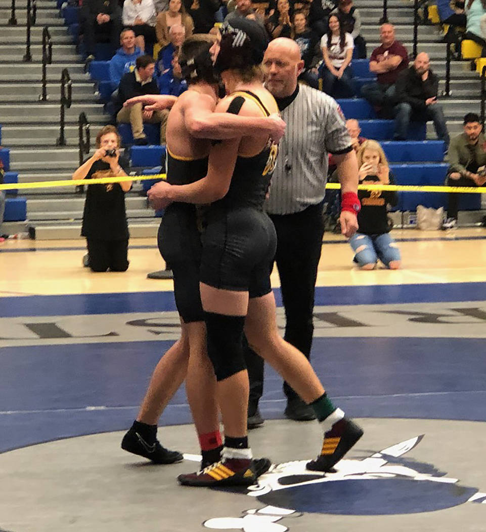 Tom Rysinski/Pahrump Valley Times Senior Tristan Maughan, left, and sophomore Dylan Wright embrace after Wright's 15-8 decision over Maughan in the Class 3A Southern Region 160-pound final Saturda ...