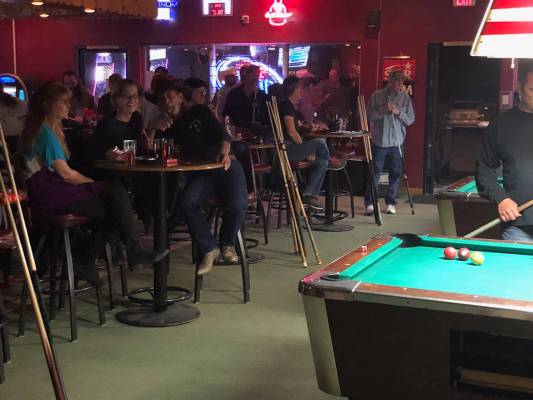 Tom Rysinski/Pahrump Valley Times Pool players and other bar patrons watch three Pahrump Valley ...