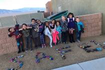 Special to the Pahrump Valley Times Local elementary school students enrolled in the school district's SAFE program, strike poses before colorful rocks painted during a recent parent engagement ni ...