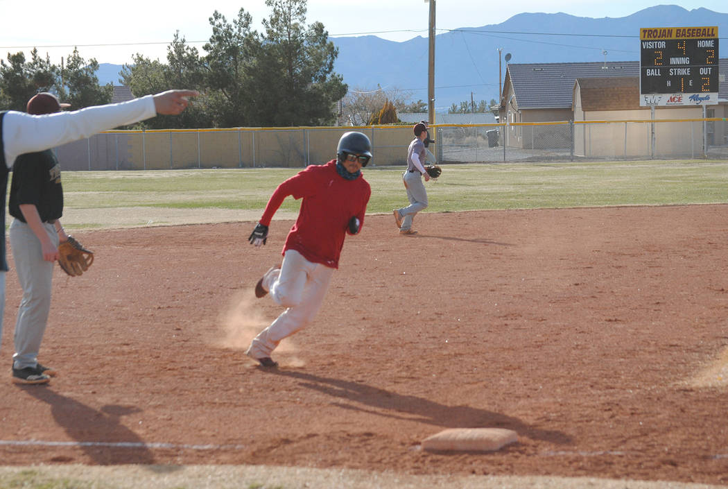 Charlotte Uyeno/Pahrump Valley Times Rounding third and heading for home, Nick Wagner, Pahrump Valley Class of 2002, returned to Pahrump from Florida and drove in two runs for the alumni team duri ...