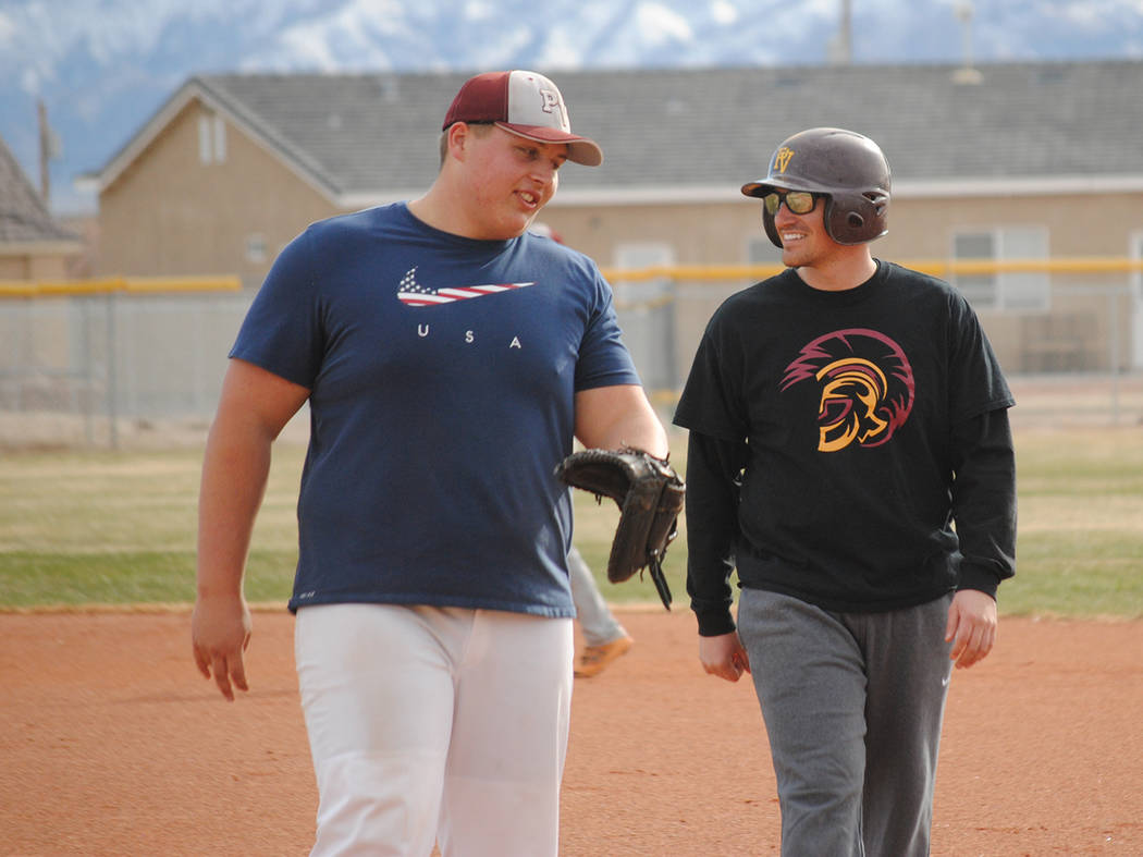 Charlotte Uyeno/Pahrump Valley Times Pahrump Valley senior Zach Trieb, left, talks with Aaron Pike, Class of 2012, during the school's Maroon and Gold Alumni Day on Saturday.
