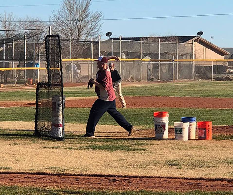 Tom Rysinski/Pahrump Valley Times Pahrump Valley High School baseball coach Brian Hayes delivers a pitch during a drill at practice Feb. 28 at the high school. Hayes is entering his seventh season ...